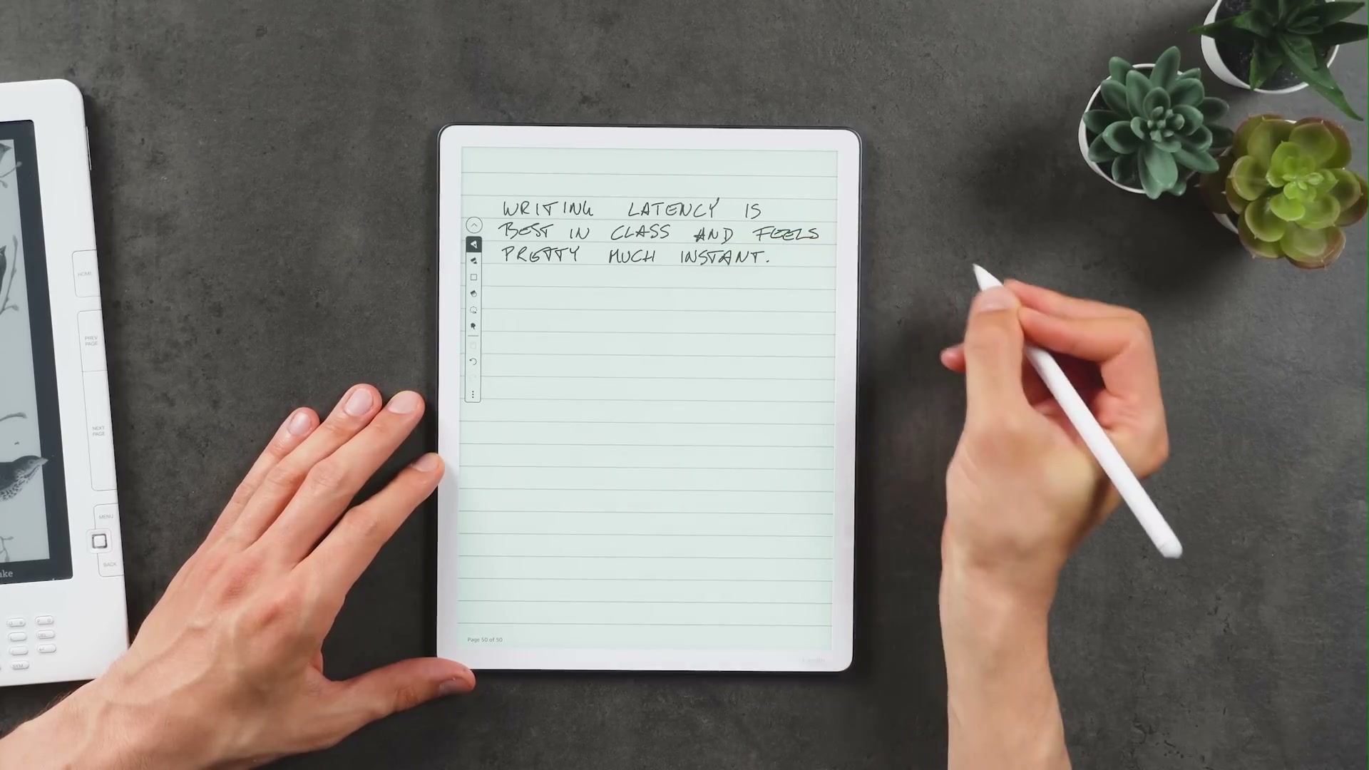 Kindle Scribe mit linierten handschriftlichen Notizen und einem weißen Stift in der rechten Hand.